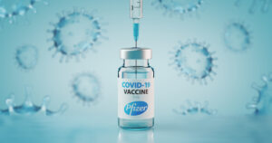 Sofia, Bulgaria - November 10, 2020: Pfizer COVID-19 Coronavirus Vaccine and Syringe. Conceptual image.