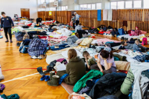 Uzhhorod, Ukraine - March 11, 2022: Internally displaced persons who fled from Russia's invasion of Ukraine rest in the gym of one of the local schools.