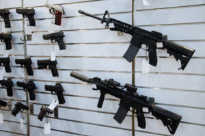 Gun wall rack with rifles and pistol.
