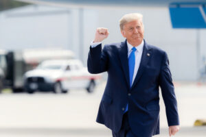 Greenville, S.C., USA - October 15 2020: Donald Trump walking outdoors, raising his fist in a gesture of triumph Greenville, S.C., USA - October 15 2020: Donald Trump walking outdoors, raising his fist in a gesture of triumph
