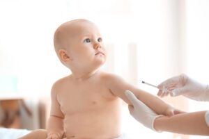 Doctor vaccinating baby in clinic Doctor vaccinating baby in clinic