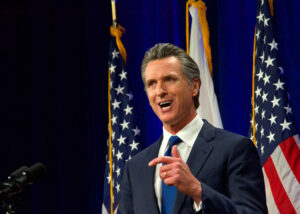 Sacramento, CA - March 8, 2022: California Governor Gavin Newsom speaking at the State of the State address in Sacramento, CA. Sacramento, CA - March 8, 2022: California Governor Gavin Newsom speaking at the State of the State address in Sacramento, CA.